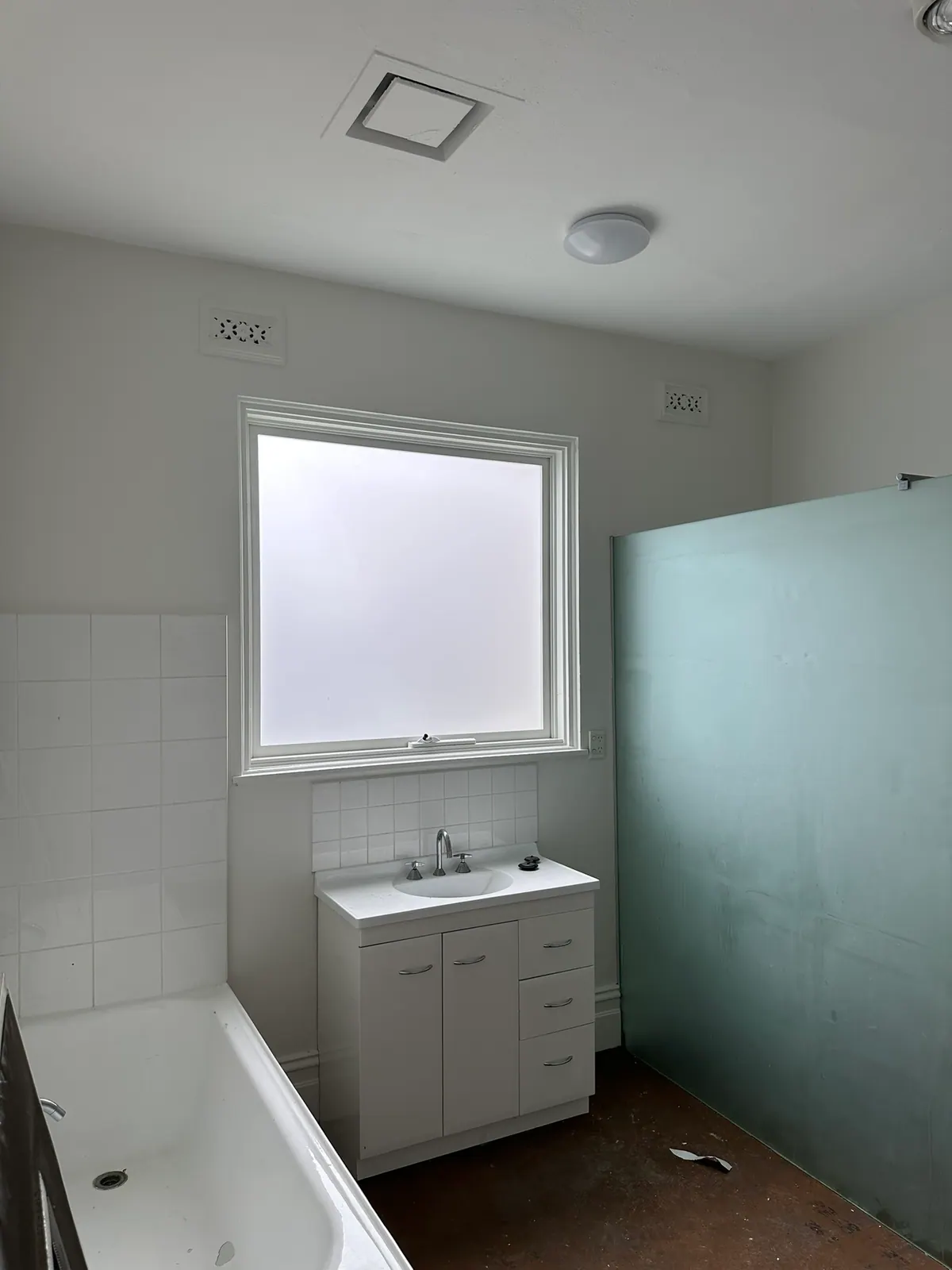 This home renovation received frosted window film to provide much-needed privacy from surrounding newly built townhouses, while still allowing plenty of natural light to brighten the bathroom.