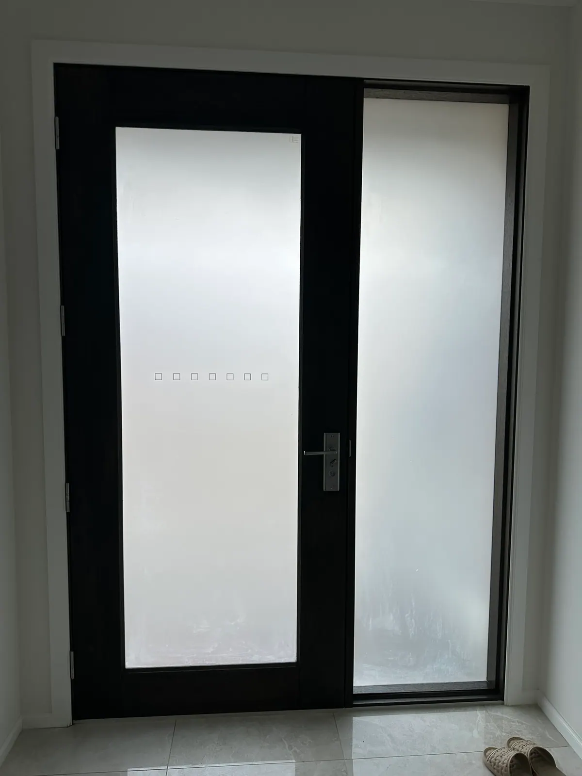 This beautiful new home received frosted privacy film across its front door and large sidelights, bringing a soft white light through the home and complete privacy from the busy new estate while giving the entry a new look.