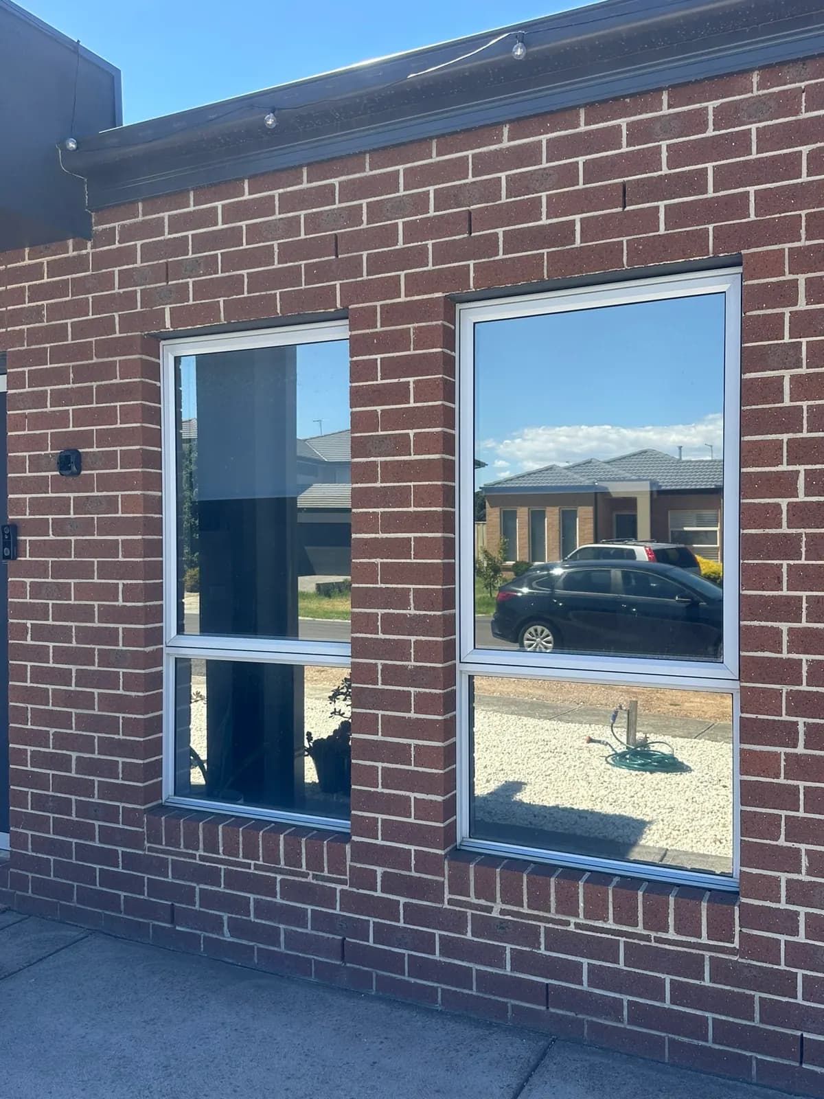 Mirror privacy tint on the front windows of a Truganina home