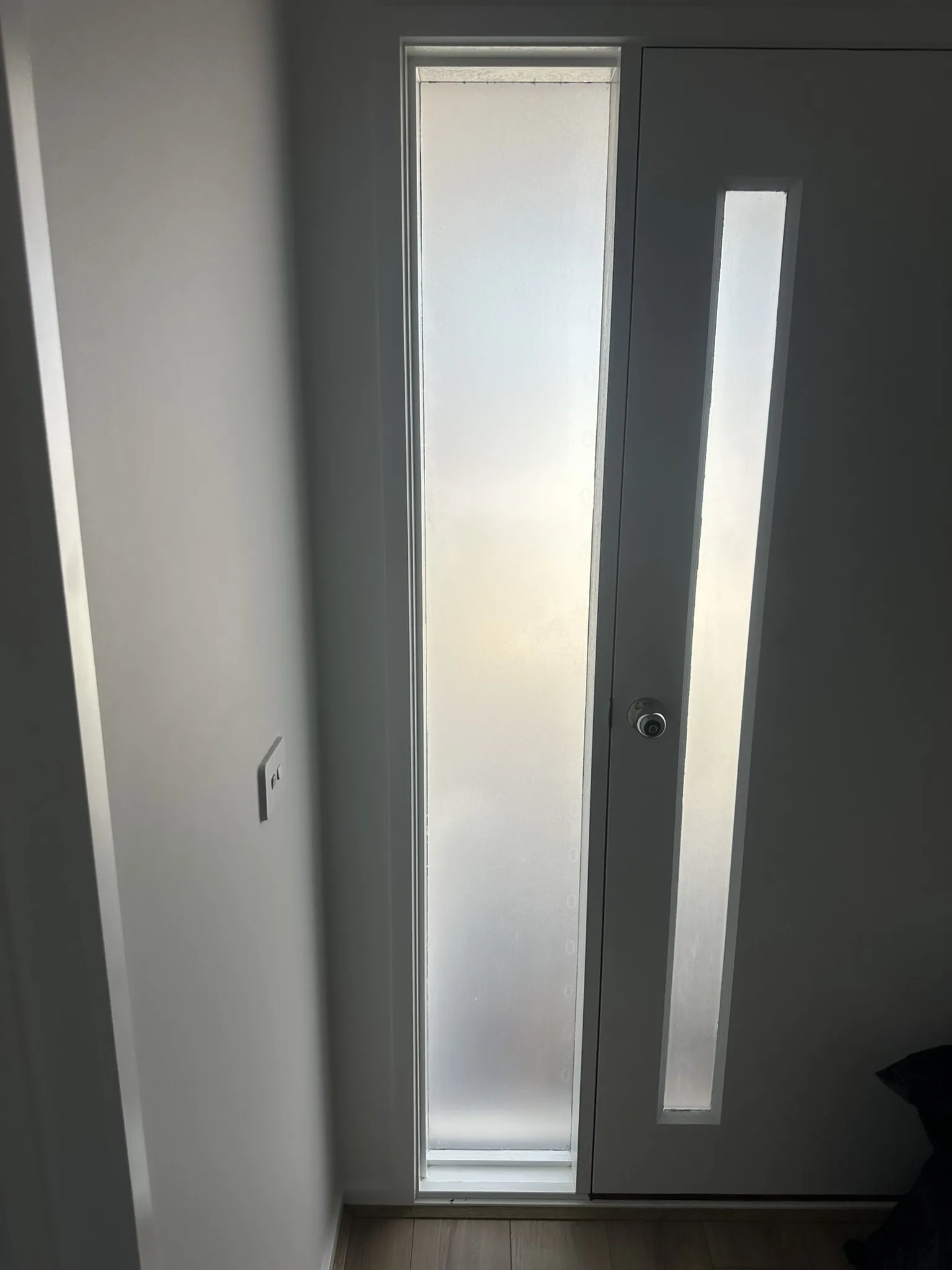 Frosted film on the full-height entry door glazing of a new build in Lara. Builders often hand over these doors with clear glass, which puts the hallway on show from the porch. Frosted film is the straightforward fix, and it works day and night because it obscures rather than reflects.