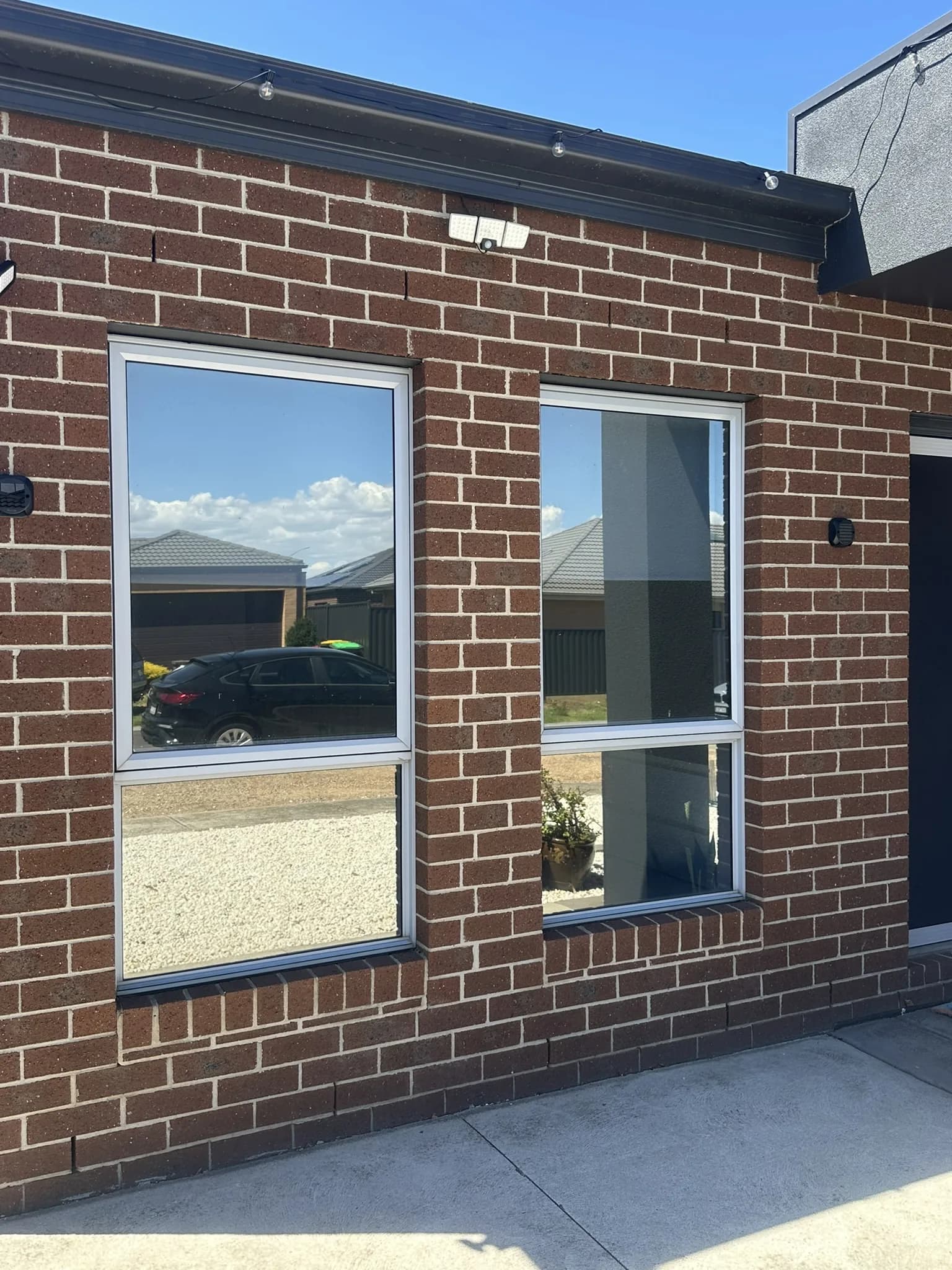 Mirror film on two front windows, reflecting the street